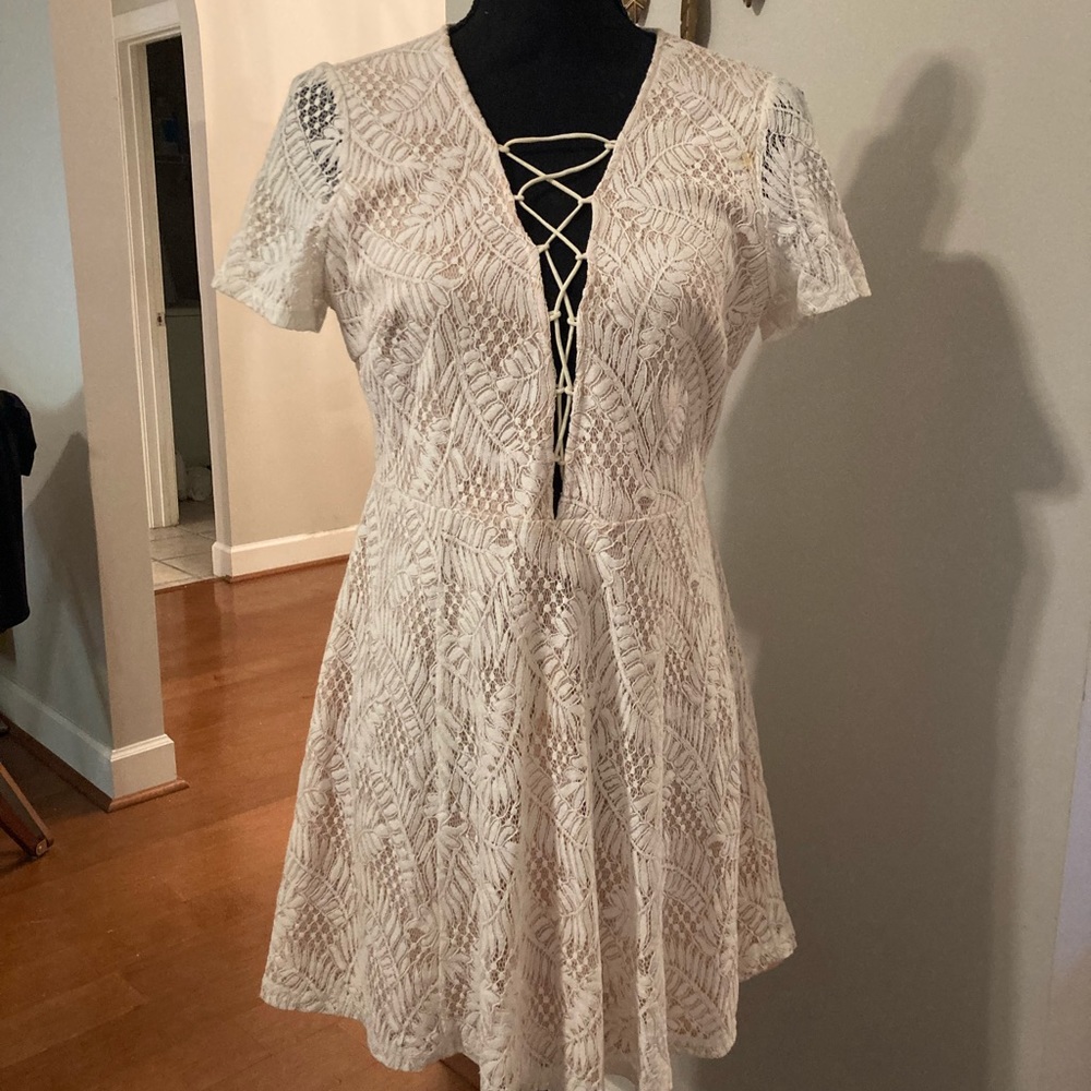 Cream lace mini dress. Laces up front